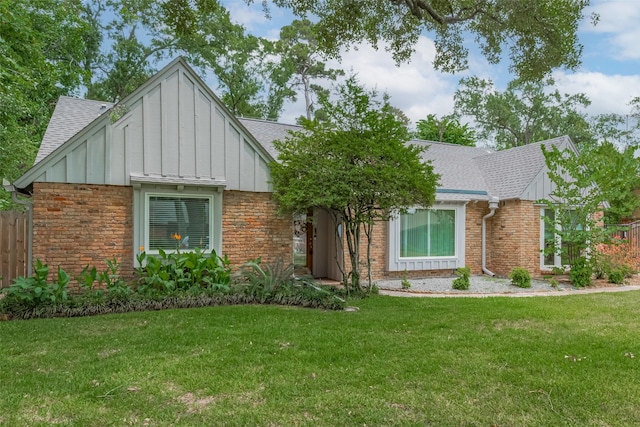 10126 Whiteside Ln, Houston, TX 77043 - tudor-style house with board and batten siding, a shingled roof, and brick siding