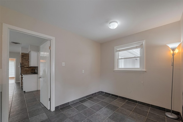 10126 Whiteside Ln, Houston, TX 77043 - empty room featuring dark tile patterned flooring and baseboards