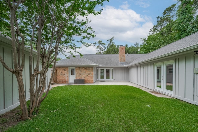 10126 Whiteside Ln, Houston, TX 77043 - back of property featuring french doors, a chimney, board and batten siding, a patio area, and a shingled roof
