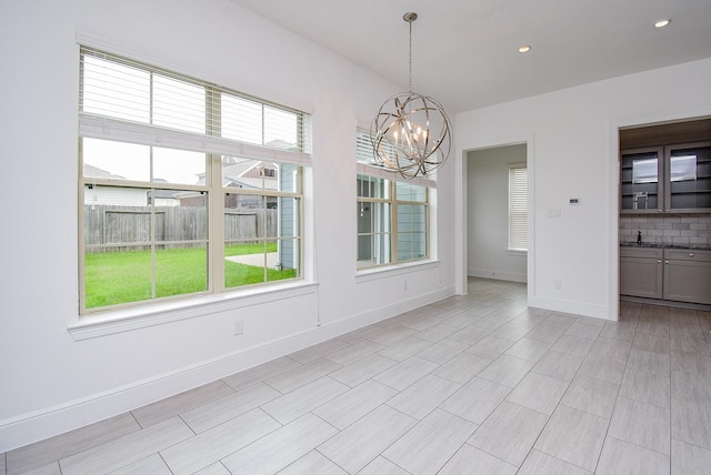 7818 Ludington Dr, Houston, TX 77071 - unfurnished dining area with healthy amount of natural light, a chandelier, baseboards, and recessed lighting