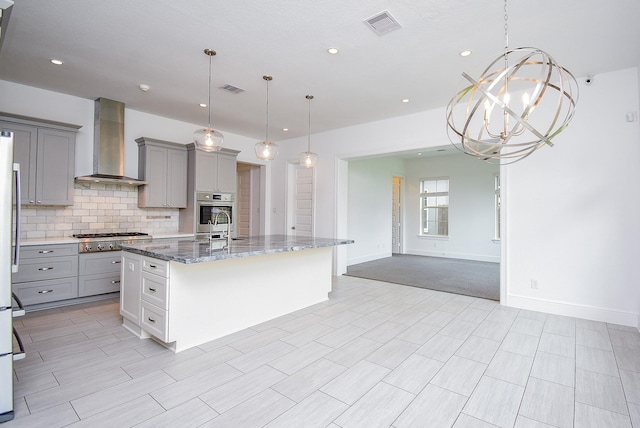 7818 Ludington Dr, Houston, TX 77071 - kitchen featuring gray cabinets, wall chimney exhaust hood, stainless steel appliances, decorative backsplash, and light stone counters