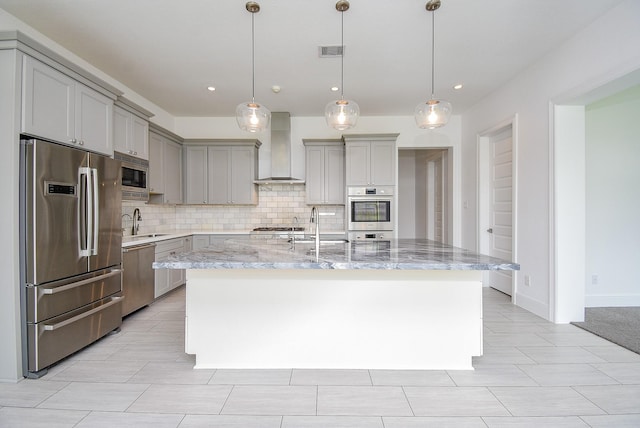 7818 Ludington Dr, Houston, TX 77071 - kitchen featuring appliances with stainless steel finishes, wall chimney range hood, gray cabinets, backsplash, and recessed lighting