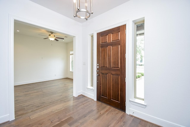 7818 Ludington Dr, Houston, TX 77071 - entrance foyer with wood finished floors, a chandelier, ceiling fan, and baseboards