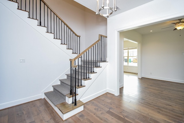 7818 Ludington Dr, Houston, TX 77071 - staircase with wood finished floors, baseboards, a chandelier, and a ceiling fan