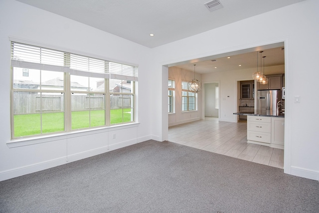7818 Ludington Dr, Houston, TX 77071 - unfurnished living room with light carpet, a chandelier, baseboards, and recessed lighting