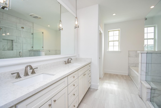 7818 Ludington Dr, Houston, TX 77071 - full bathroom with a garden tub, double vanity, a stall shower, baseboards, and recessed lighting