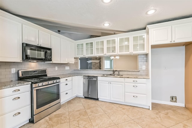 10901 Mesquite Dr, La Porte, TX 77571 - kitchen with stainless steel appliances, a sink, glass insert cabinets, decorative backsplash, and white cabinets