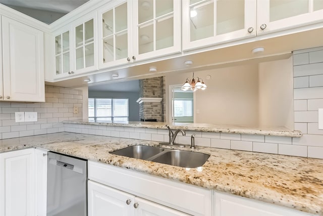 10901 Mesquite Dr, La Porte, TX 77571 - kitchen featuring stainless steel dishwasher, a sink, backsplash, and white cabinets