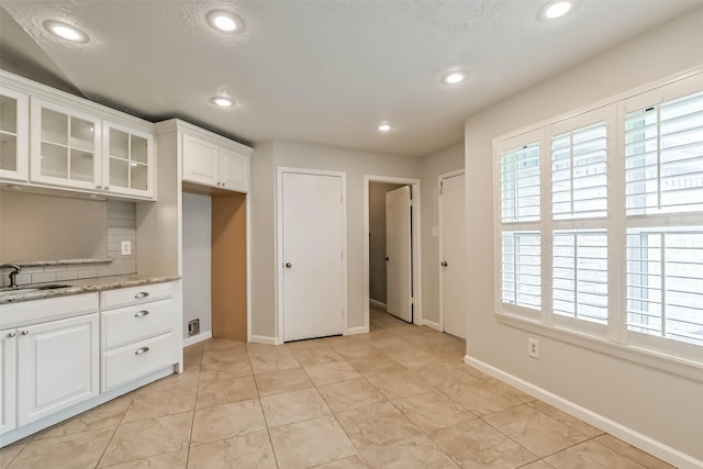 10901 Mesquite Dr, La Porte, TX 77571 - kitchen with a sink, healthy amount of natural light, white cabinetry, glass insert cabinets, and recessed lighting