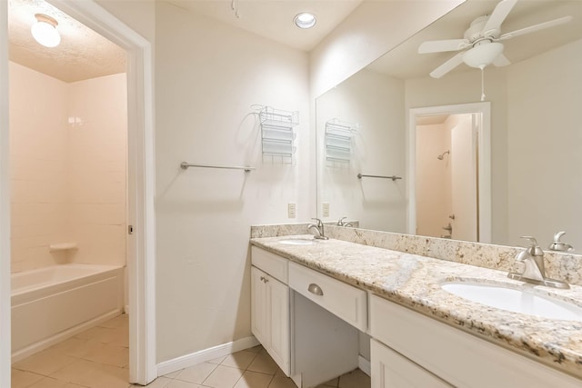 10901 Mesquite Dr, La Porte, TX 77571 - full bathroom with double vanity, tile patterned floors, ceiling fan, washtub / shower combination, and baseboards