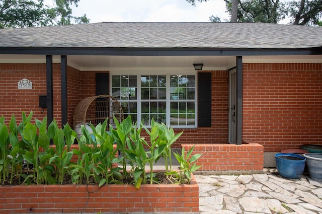 2302 Hewitt Dr, Houston, TX 77018 - entrance to property with a shingled roof and brick siding