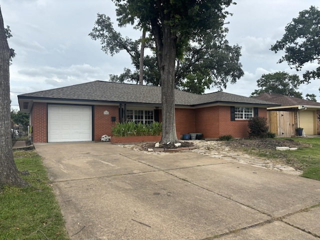 2302 Hewitt Dr, Houston, TX 77018 - ranch-style home with brick siding, a garage, and driveway