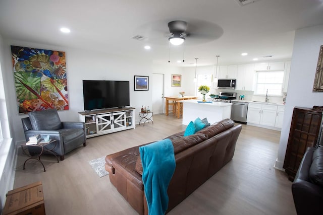 2302 Hewitt Dr, Houston, TX 77018 - living area with light wood-style flooring, ceiling fan, and recessed lighting