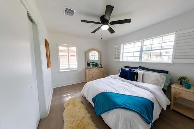2302 Hewitt Dr, Houston, TX 77018 - bedroom with multiple windows, wood finished floors, baseboards, and ceiling fan
