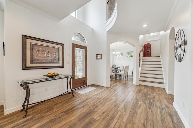 4303 Stonebrook Ln, Missouri City, TX 77459 - entrance foyer featuring wood finished floors, stairs, a chandelier, ornamental molding, and baseboards