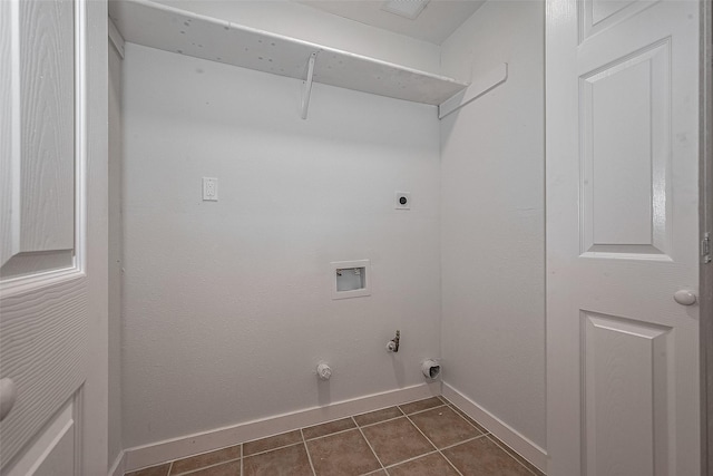 7119 Piney Meadow Ct, Houston, TX 77041 - laundry area featuring baseboards, hookup for a washing machine, hookup for an electric dryer, dark tile patterned floors, and gas dryer hookup