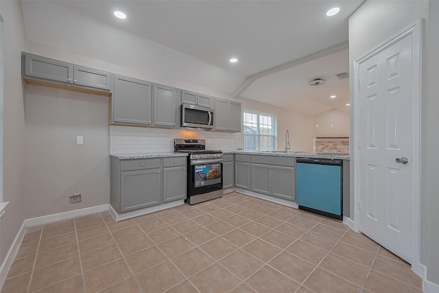 7119 Piney Meadow Ct, Houston, TX 77041 - kitchen with appliances with stainless steel finishes, gray cabinets, a sink, tasteful backsplash, and light tile patterned flooring