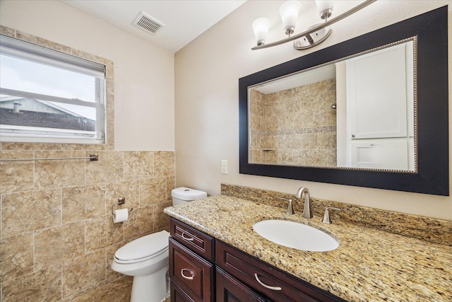 5211 W Bellfort Ave, Houston, TX 77035 - bathroom with vanity, toilet, tile walls, and tiled shower