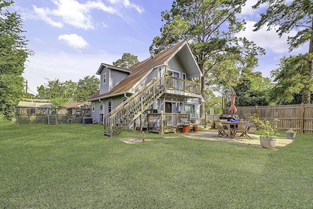 1239 Indian Hill Blvd, Livingston, TX 77351 - back of house featuring a deck, a patio area, central AC, and stairs