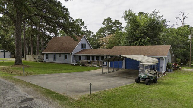 1239 Indian Hill Blvd, Livingston, TX 77351 - view of front facade featuring a detached carport, driveway, and a front yard