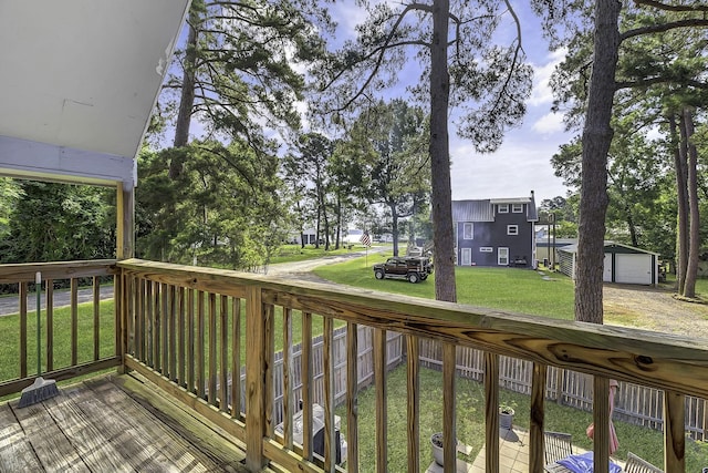1239 Indian Hill Blvd, Livingston, TX 77351 - deck with a yard, a residential view, an outbuilding, and a detached garage