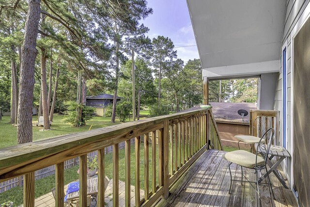 1239 Indian Hill Blvd, Livingston, TX 77351 - wooden deck featuring a yard and view of wooded area