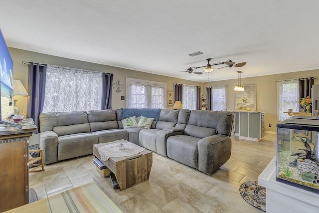 1239 Indian Hill Blvd, Livingston, TX 77351 - living area featuring healthy amount of natural light, ceiling fan, baseboards, and ornamental molding