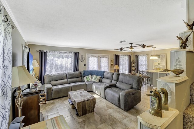 1239 Indian Hill Blvd, Livingston, TX 77351 - living area with a ceiling fan, crown molding, and a textured ceiling