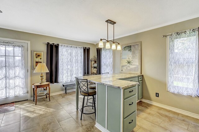 1239 Indian Hill Blvd, Livingston, TX 77351 - kitchen featuring green cabinets, plenty of natural light, a breakfast bar area, and crown molding