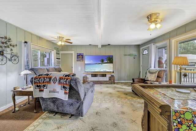 1239 Indian Hill Blvd, Livingston, TX 77351 - carpeted living area featuring ceiling fan, beam ceiling, and a decorative wall