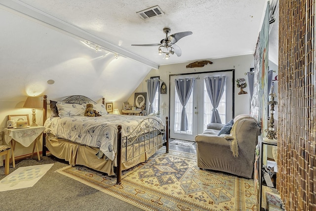 1239 Indian Hill Blvd, Livingston, TX 77351 - carpeted bedroom featuring rail lighting, access to exterior, lofted ceiling, a textured ceiling, and ceiling fan