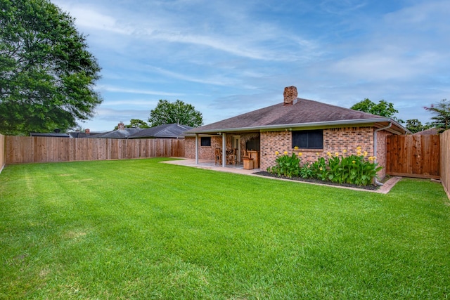 5214 Meadow Crest St, La Porte, TX 77571 - rear view of house with a chimney, a patio area, brick siding, and a shingled roof