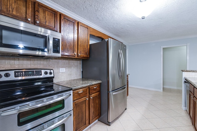 5214 Meadow Crest St, La Porte, TX 77571 - kitchen with stainless steel appliances, tasteful backsplash, baseboards, crown molding, and a textured ceiling