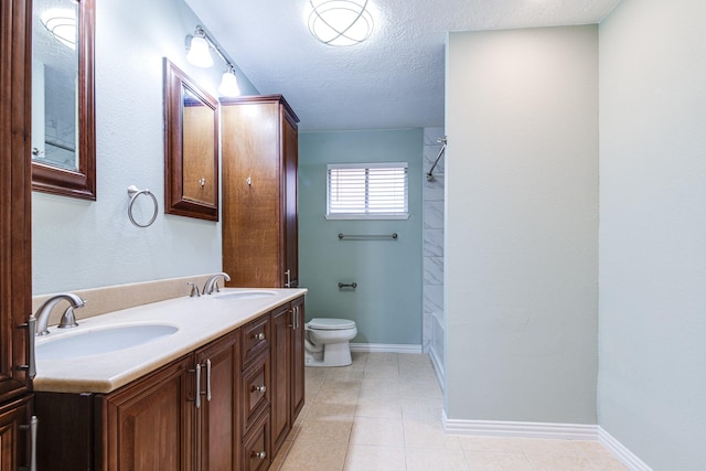 5214 Meadow Crest St, La Porte, TX 77571 - full bathroom with double vanity, toilet, a textured ceiling, tile patterned flooring, and washtub / shower combination