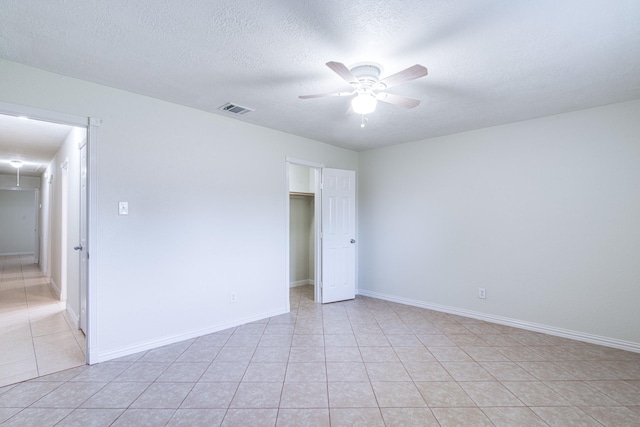 5214 Meadow Crest St, La Porte, TX 77571 - unfurnished room with a ceiling fan, light tile patterned floors, baseboards, and a textured ceiling