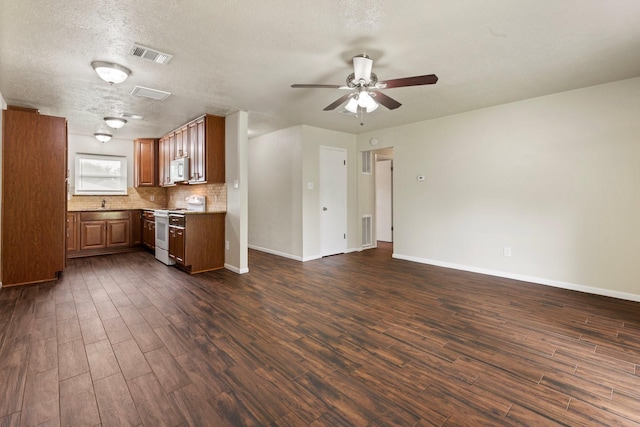 1121 E 13th St, Deer Park, TX 77536 - kitchen featuring white appliances, dark wood-style flooring, ceiling fan, baseboards, and open floor plan