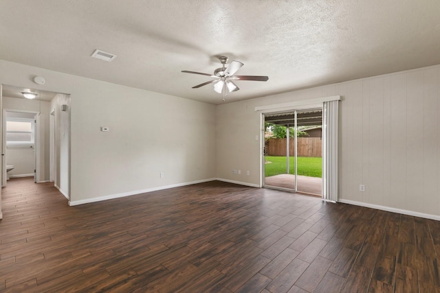 1121 E 13th St, Deer Park, TX 77536 - empty room featuring a ceiling fan, dark wood-type flooring, baseboards, a textured ceiling, and a smoke detector