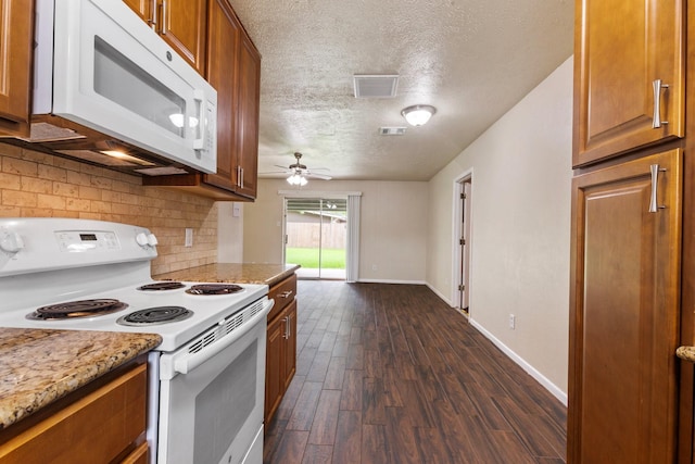 1121 E 13th St, Deer Park, TX 77536 - kitchen featuring white appliances, dark wood-type flooring, brown cabinetry, backsplash, and ceiling fan