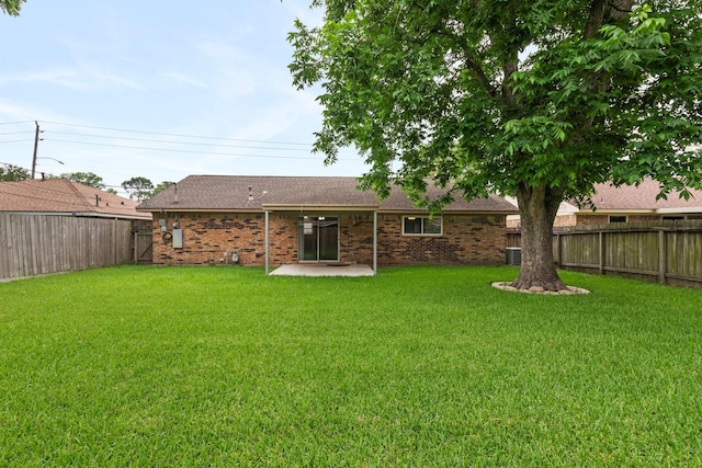 1121 E 13th St, Deer Park, TX 77536 - rear view of property with brick siding, a shingled roof, a patio area, and central AC