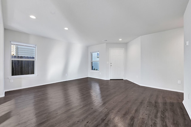 4354 Tulip Oak Dr, Houston, TX 77068 - unfurnished living room with dark wood-type flooring, baseboards, recessed lighting, and healthy amount of natural light