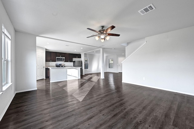 4354 Tulip Oak Dr, Houston, TX 77068 - unfurnished living room featuring a ceiling fan, healthy amount of natural light, dark wood-style flooring, baseboards, and recessed lighting