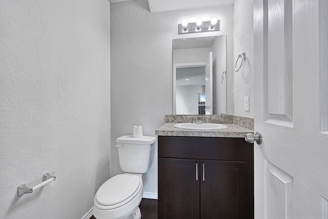 4354 Tulip Oak Dr, Houston, TX 77068 - half bathroom featuring vanity, a textured wall, and toilet