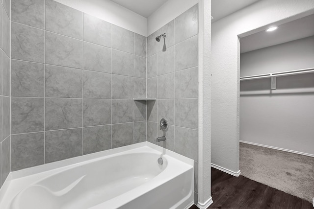 4354 Tulip Oak Dr, Houston, TX 77068 - bathroom featuring shower / bathtub combination, wood finished floors, a spacious closet, and baseboards