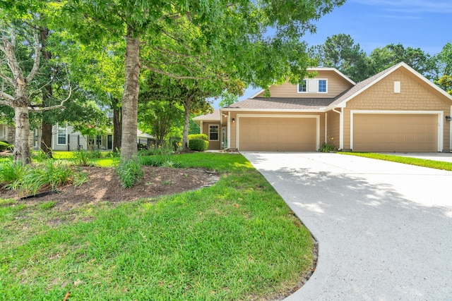 14 Fitzroy Pl, Conroe, TX 77384 - view of front of property with a garage, concrete driveway, a front lawn, and a shingled roof