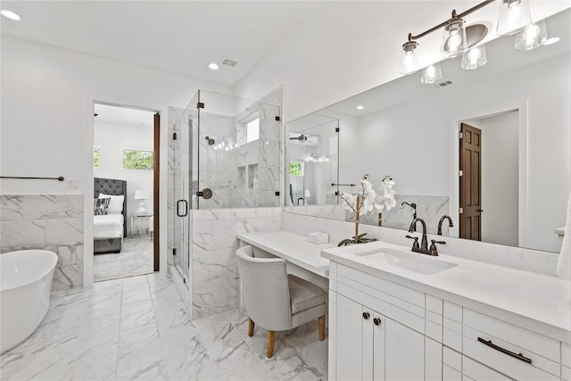 2022 Thonig Rd Unit C, Houston, TX 77055 - ensuite bathroom with tile walls, a soaking tub, a marble finish shower, vanity, and marble finish flooring