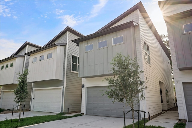 2022 Thonig Rd Unit C, Houston, TX 77055 - view of front of house featuring board and batten siding, a garage, and driveway