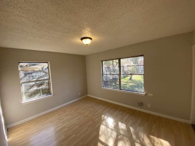 5810 Belmark St, Houston, TX 77033 - spare room with a textured ceiling, wood finished floors, and baseboards