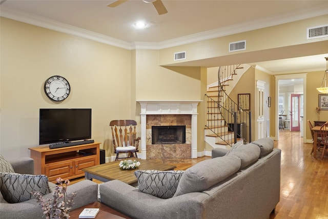 606 E 27th St, Houston, TX 77008 - living area featuring stairs, crown molding, a fireplace, wood finished floors, and a ceiling fan