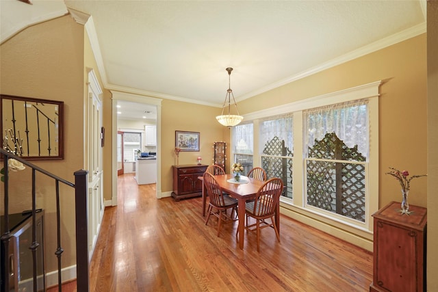 606 E 27th St, Houston, TX 77008 - dining area with crown molding, plenty of natural light, wood finished floors, and baseboards