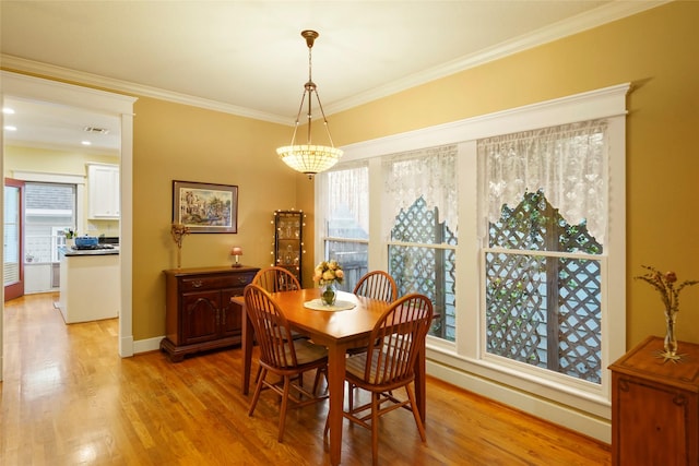 606 E 27th St, Houston, TX 77008 - dining space featuring light wood-style floors, healthy amount of natural light, ornamental molding, and baseboards
